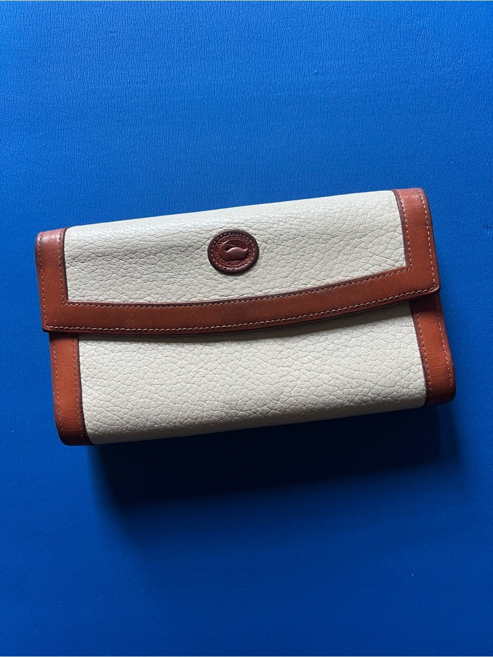 Dooney & Bourke Cream Leather Wristlet with Brown Trim and Logo